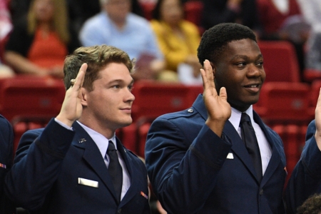 Air Force ROTC cadets raise hands and take their oaths during commissioning ceremony where they will become Second Lieutenants.