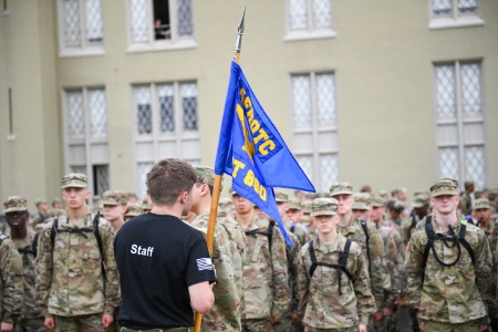Air Force ROTC Detachment 880 cadet staff holds flag while organizing cadets.