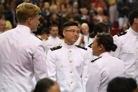 Navy ROTC graduates smile following their commissioning ceremony.