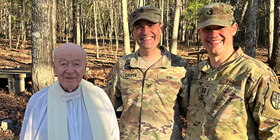 A Catolic priest poses with VMI cadets following a Sunday Mass during military training exercises at this military school in Virginia.