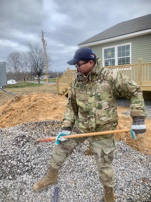 VMI cadet shovels gravel during a service project.