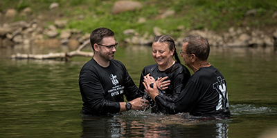 A cadet at VMI is baptized in the Maury River.