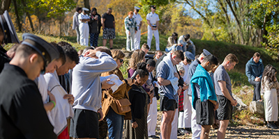 Cadets and family gather for a riverside service during Family Weekend at VMI.