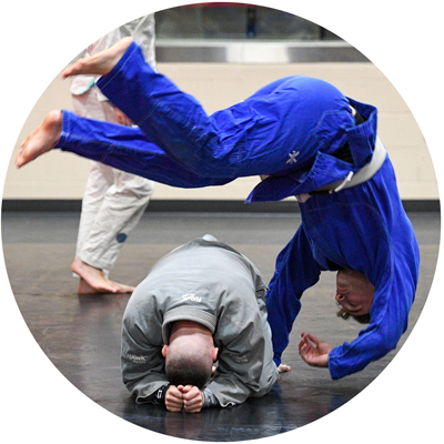Jiu-Jitsu Club cadet members practicing rolls in dojo photo circle