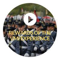 Button indicating click to play video about the Rewards of the VMI experience. Button has of cadets in Parade 
