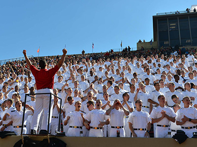 A large crowd cheers on the Keydets during a home football game.