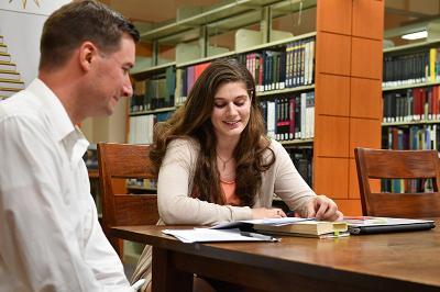 Maj. Steve Knepper and Maddy Moger '20 discuss her research on fairy tales.—VMI Photo by Mary Price.