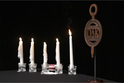 ODK 2021 Induction Ceremony table with candles and ODK figure.—VMI Photo by H. Lockwood McLaughlin.