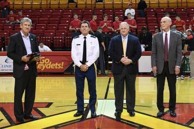 Jim Schaus, Southern Conference commissioner, recognizes Col. James “Jimmy” Coale, Michael Marshall, Dr. David Copeland