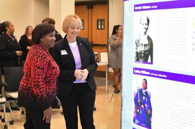 Chief Warrant Officer Phyllis J. Wilson shows Lt. Gen. Gwen Bingham the “Color of Freedom” exhibit in Preston Library during an opening reception April 15.—VMI Photo by Kelly Nye.