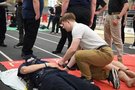 A cadet talks to a human victim of the simulated MCI.