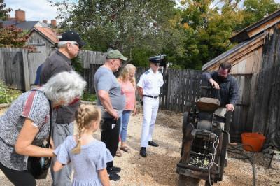 Adam Moyer operates a 19th century cider press for visitors to Apple Day