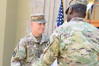 Maj. Gen. Cedric T. Wins ’85 passes the guidon to Col. Lawrence Havird ’90, during the change of leadership ceremony. -- VMI Photo by Kelly Nye.